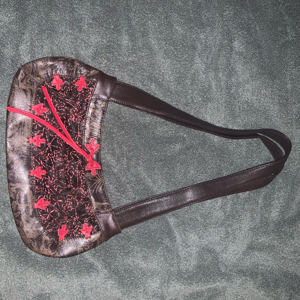 Beautiful leather bag with pink accents.